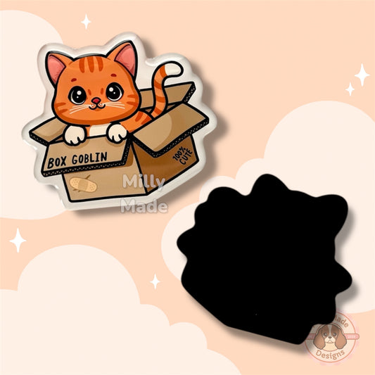 Magnet of a cat in a box with 'Box Goblin' text on a beige background, featuring the brand 'Milly Made'.